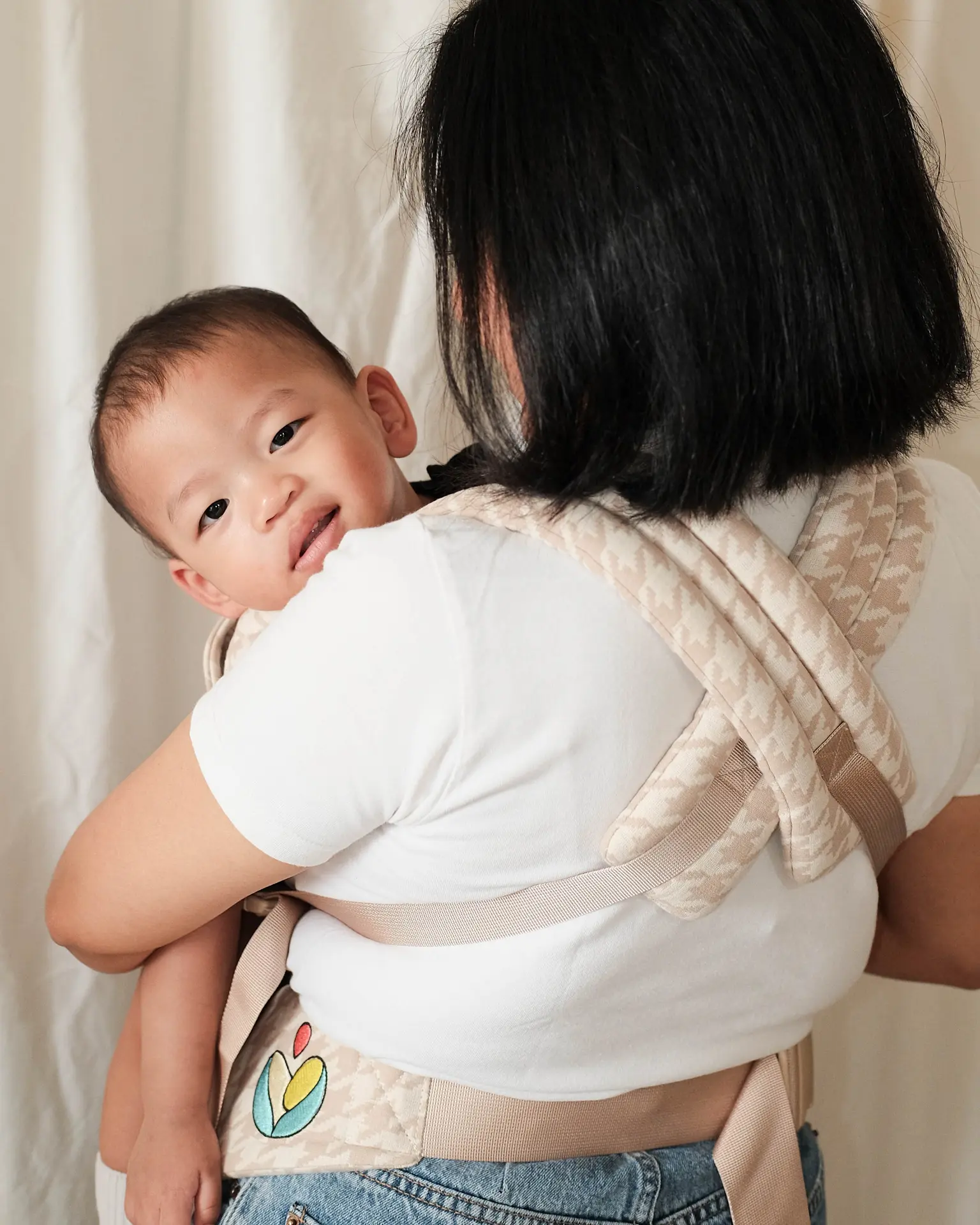 Baby carrier in use at home